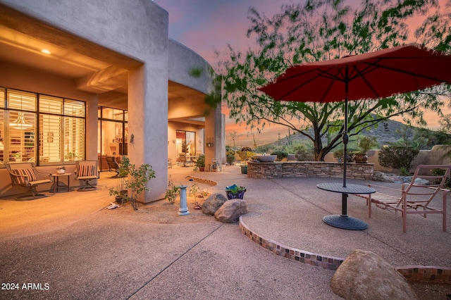 view of patio terrace at dusk