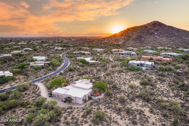 aerial view at dusk featuring a mountain view