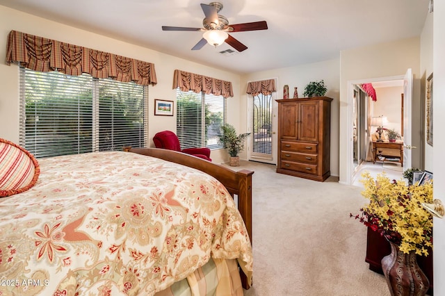 bedroom featuring ceiling fan, access to outside, visible vents, and light colored carpet