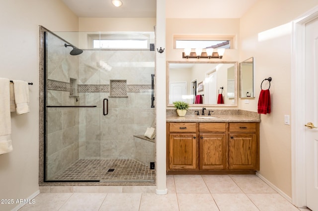 bathroom with a shower stall, tile patterned flooring, and vanity