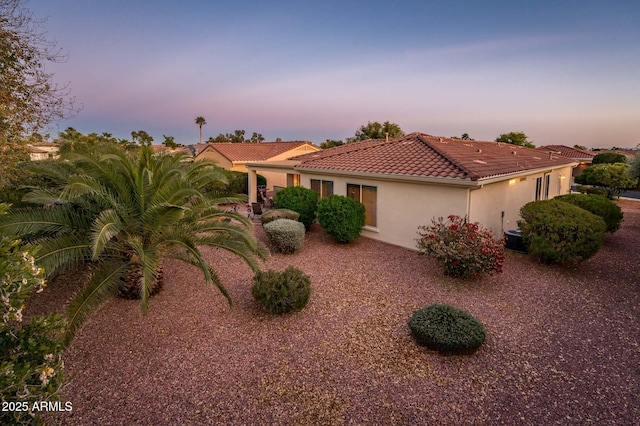 view of front of house featuring a tile roof and stucco siding