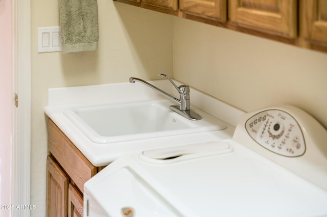 interior details featuring washer and clothes dryer and a sink