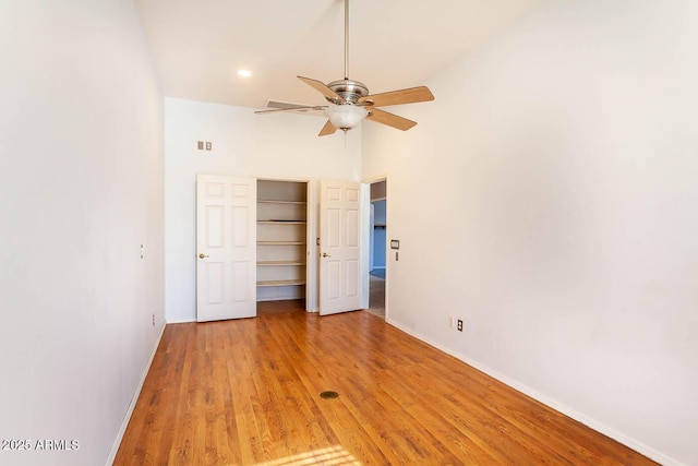 unfurnished bedroom with ceiling fan, a closet, and light hardwood / wood-style flooring