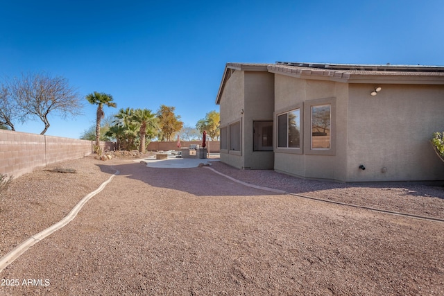 view of side of property with a patio