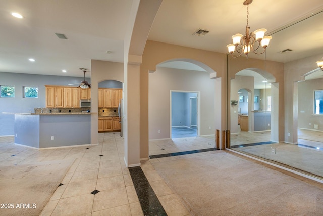 interior space featuring pendant lighting, decorative backsplash, plenty of natural light, and stainless steel appliances