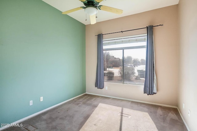 unfurnished room with light colored carpet and ceiling fan