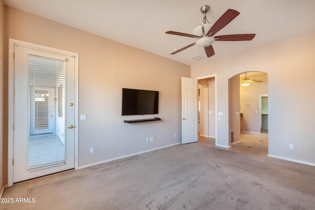 unfurnished living room with light colored carpet and ceiling fan