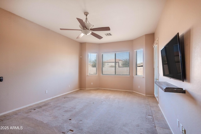 empty room featuring light carpet and ceiling fan