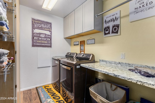 4321 E Morenci Rd, San Tan Valley, AZ 85143 - washroom featuring cabinet space, wood finished floors, washer and dryer, and baseboards
