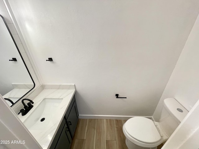 bathroom featuring hardwood / wood-style flooring, vanity, and toilet