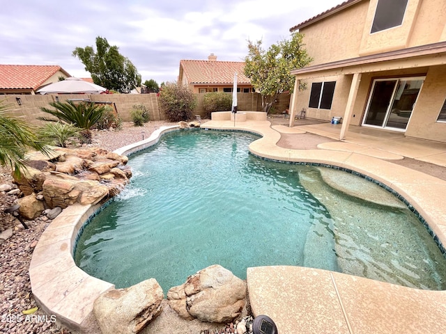 view of pool with pool water feature and a patio area