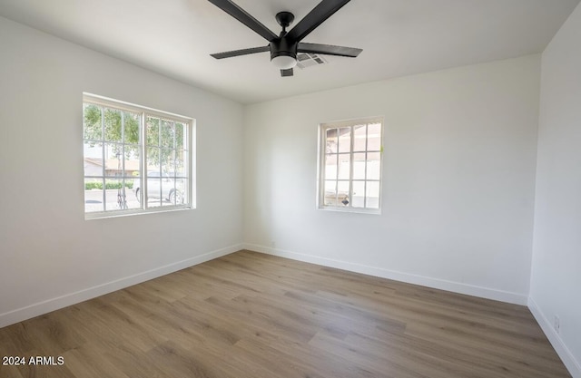 unfurnished room with ceiling fan, a healthy amount of sunlight, and light hardwood / wood-style flooring