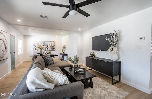 living room featuring ceiling fan and light hardwood / wood-style flooring