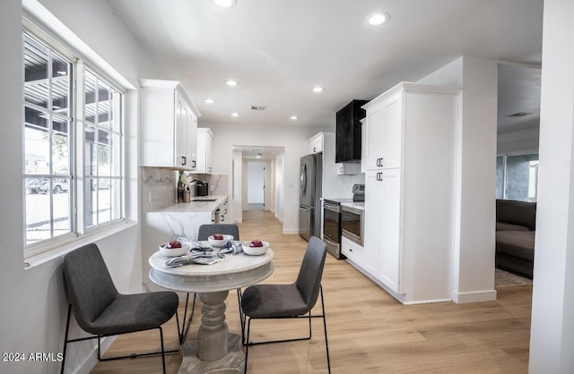 dining area featuring light hardwood / wood-style flooring and sink