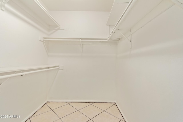 spacious closet featuring light tile patterned flooring