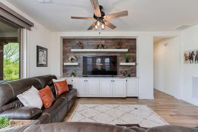 4350 Stage Stop Way, Wickenburg, AZ 85390 - living room with light wood finished floors, ceiling fan, and baseboards