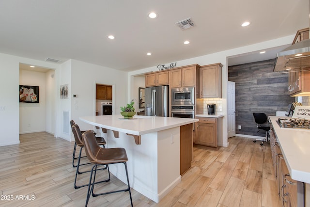 4350 Stage Stop Way, Wickenburg, AZ 85390 - kitchen featuring appliances with stainless steel finishes, light wood-style floors, brown cabinets, and recessed lighting