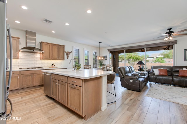 4350 Stage Stop Way, Wickenburg, AZ 85390 - kitchen featuring wall chimney exhaust hood, open floor plan, appliances with stainless steel finishes, a sink, and recessed lighting