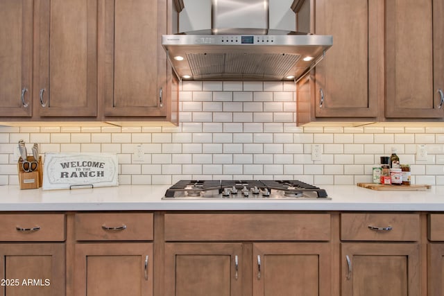 4350 Stage Stop Way, Wickenburg, AZ 85390 - kitchen with wall chimney range hood, stainless steel gas cooktop, light countertops, and decorative backsplash