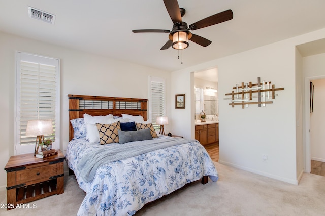 4350 Stage Stop Way, Wickenburg, AZ 85390 - bedroom featuring light carpet, baseboards, ensuite bathroom, and a ceiling fan
