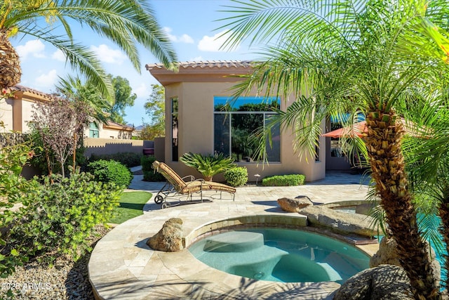 view of swimming pool featuring a patio area and an in ground hot tub