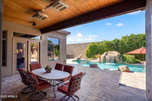 view of patio with pool water feature and a fenced in pool