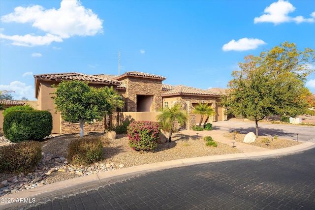 mediterranean / spanish home featuring a garage