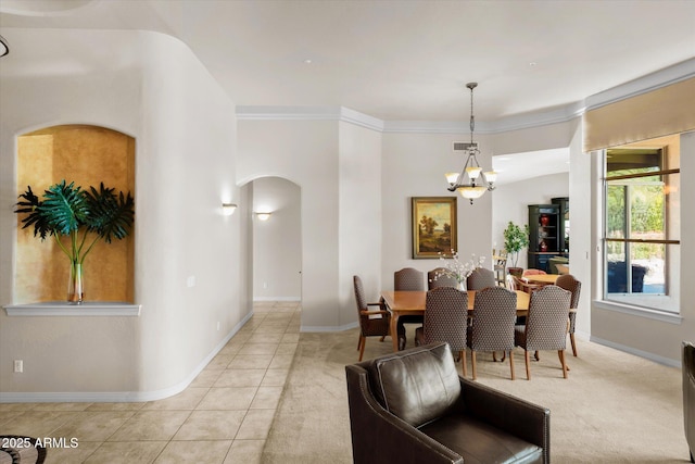 dining space featuring light tile patterned floors, a notable chandelier, and ornamental molding