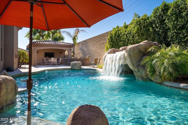 view of pool with pool water feature and a patio area