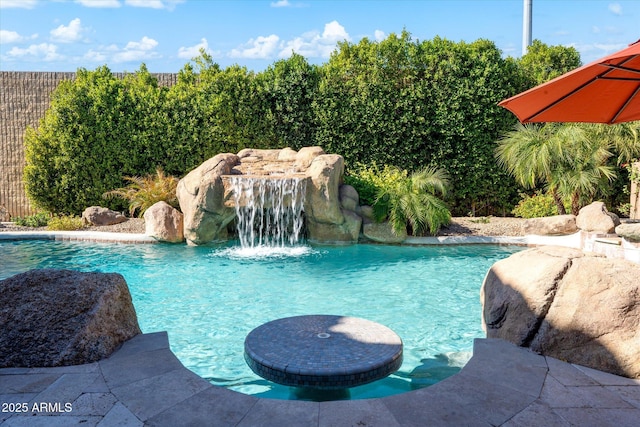 view of pool with pool water feature