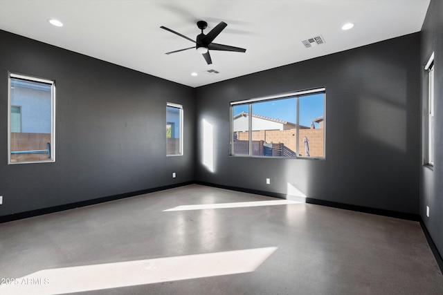 unfurnished room featuring ceiling fan and concrete flooring