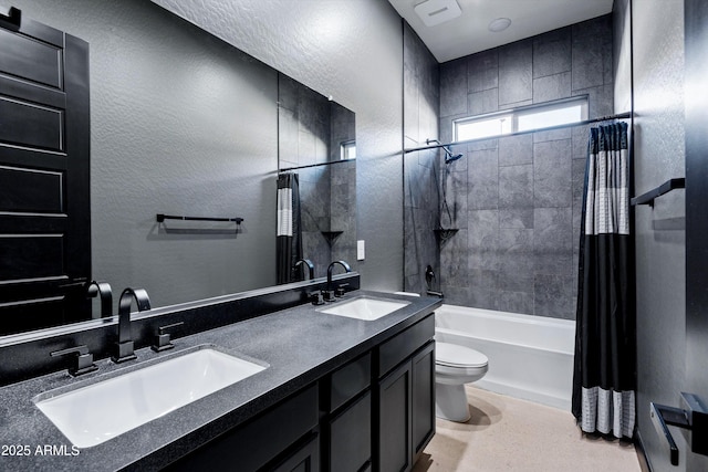 full bathroom with vanity, shower / tub combo, and toilet