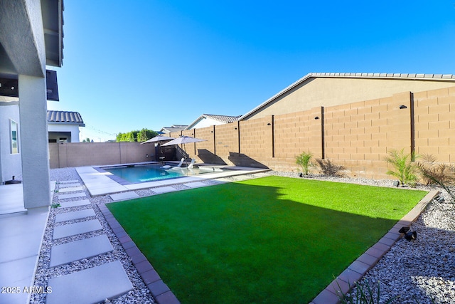 view of yard with a fenced in pool and a patio