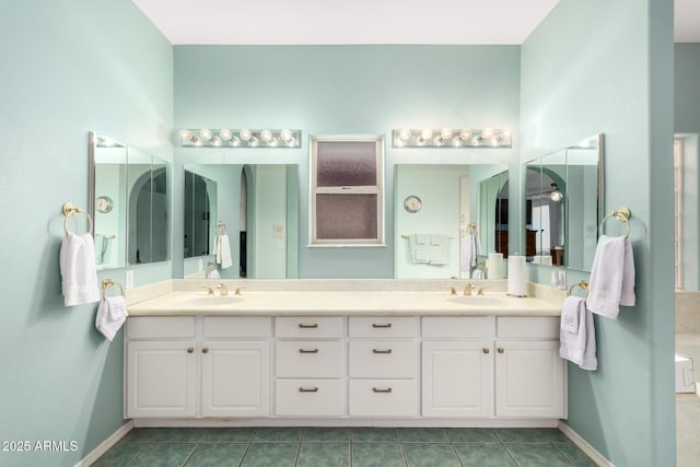 bathroom with tile patterned floors and vanity