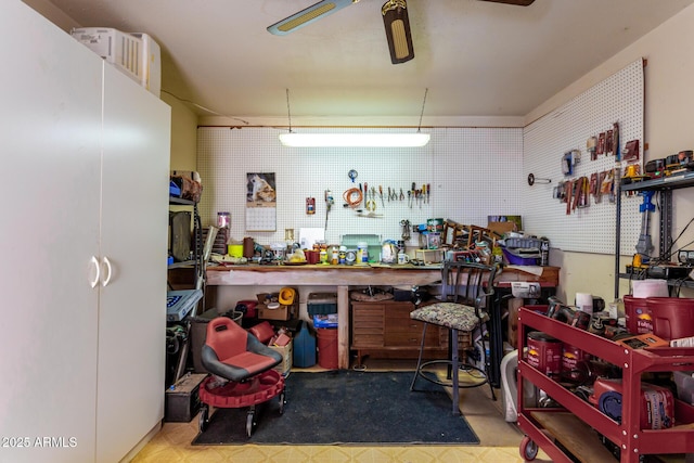 interior space with a workshop area and ceiling fan