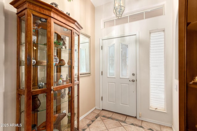 foyer entrance with light tile patterned flooring