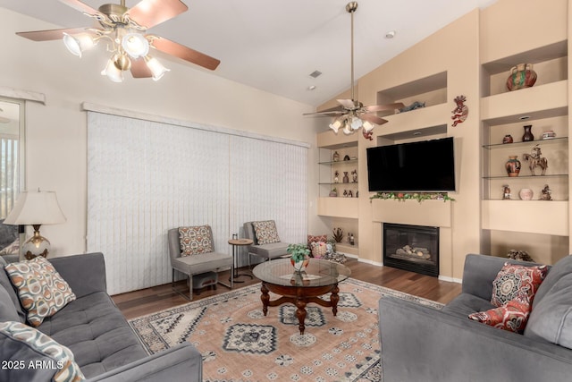 living room with high vaulted ceiling, dark wood-type flooring, built in features, and ceiling fan