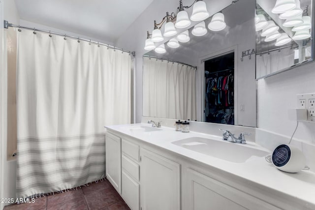 bathroom featuring a sink, a shower with curtain, double vanity, and tile patterned flooring