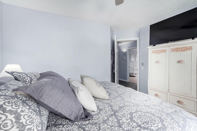 bedroom with a textured ceiling, ceiling fan, and radiator heating unit