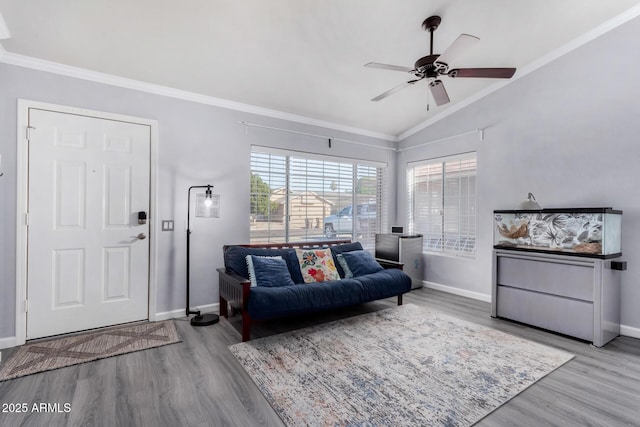 living room featuring ornamental molding, a ceiling fan, and wood finished floors