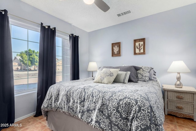 bedroom with tile patterned flooring, multiple windows, and visible vents