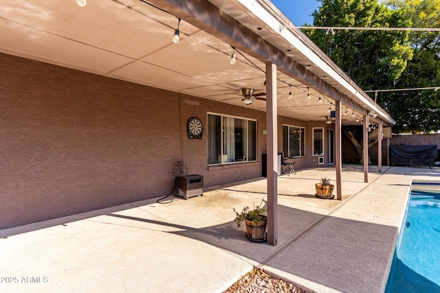 view of patio / terrace with a fenced in pool, a ceiling fan, and fence