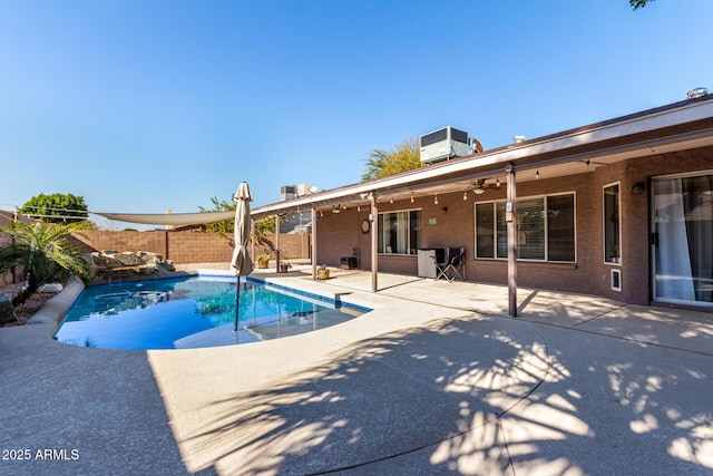 view of pool featuring a ceiling fan, a fenced in pool, a fenced backyard, central AC, and a patio area