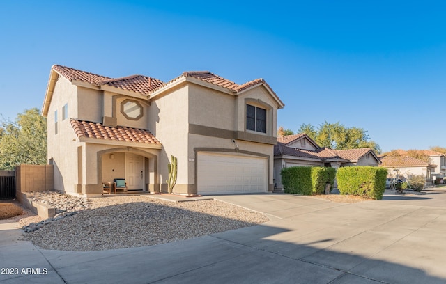 mediterranean / spanish-style house with a garage