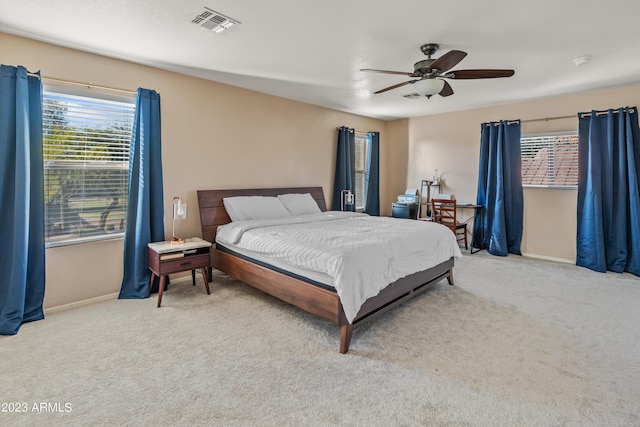 bedroom with ceiling fan and light colored carpet