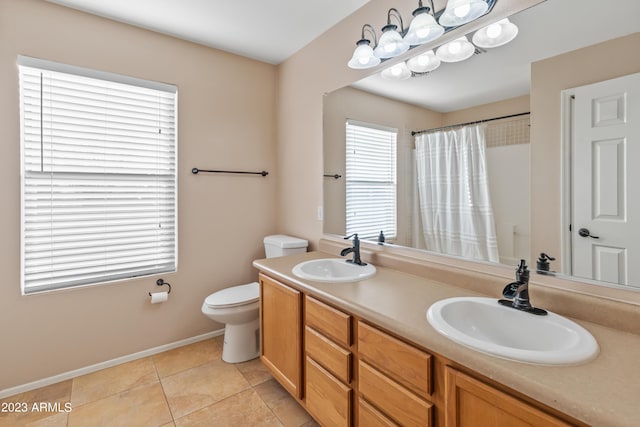 bathroom featuring toilet, tile patterned floors, a shower with shower curtain, and vanity