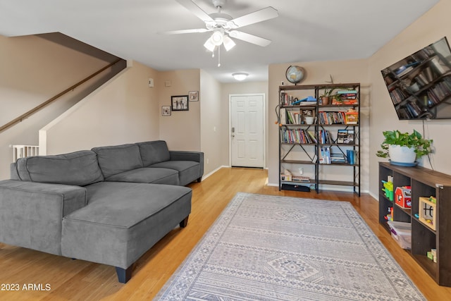 living room featuring ceiling fan and light hardwood / wood-style floors