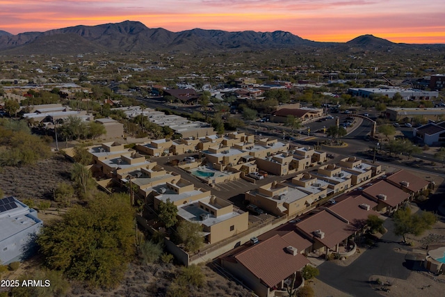 aerial view at dusk featuring a mountain view