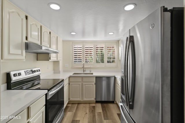 kitchen featuring appliances with stainless steel finishes, dark hardwood / wood-style flooring, and sink