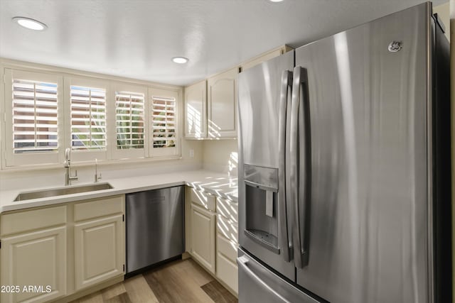 kitchen featuring light wood-type flooring, sink, and stainless steel appliances